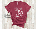 Rockin This Life Cute RN Tshirt Gift for Nurse Appreciation RN Granduation Rockin Life Funny Nurse Tshirt Gifts Nurse Gifts Graphic Tee – Soft Feel · Top Pick For Any Outfit
