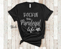 Rockin This Life Paralegal Shirt Gifts for Paralegal Funny Paralegal Office Tshirt for Paralegal Student Gift or Graduation Gift Graphic Tee – Soft Feel · Top Pick For Any Outfit