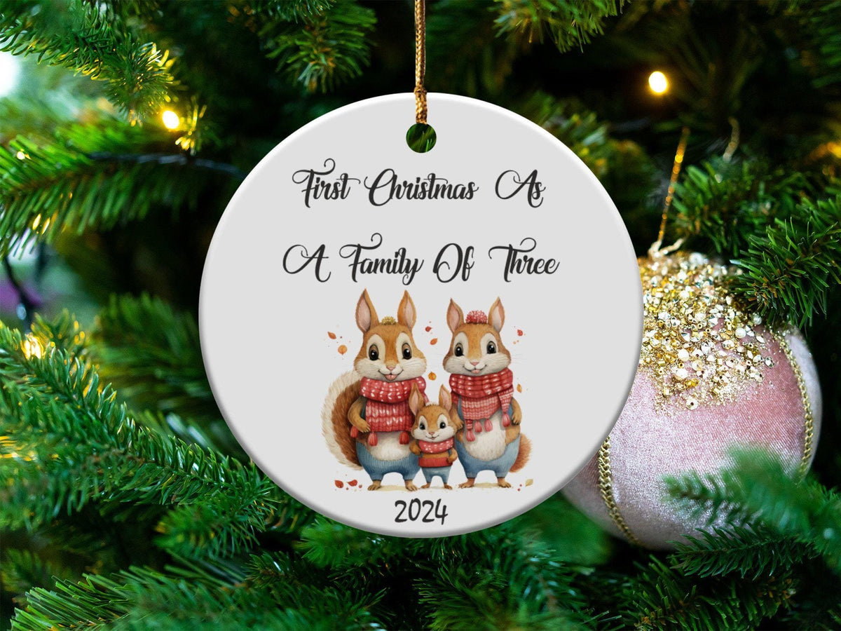 Xmas Ornament First Christmas As A Family Of Three 3 Inch Ceramic Ornament With Presentation Box Christmas Family Of Three Ornament 2024 Graphic Tee – Soft Feel · Perfect For Daily Wear