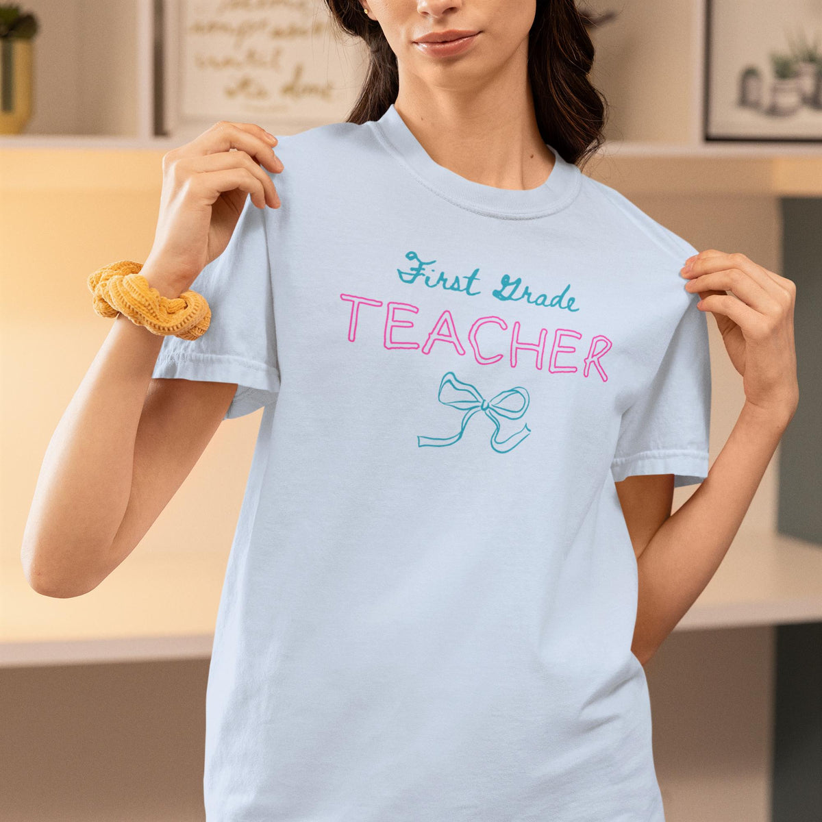 First Grade Teacher Tee Shirt with Bow Graduation Gift for Elementary Education Major or Cute Congratulations Present for New Teacher Graphic Tee – Feel-Good Design · High-Quality Print
